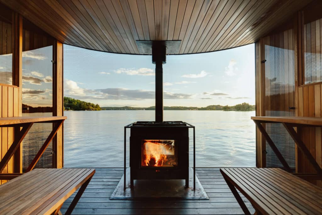 The custom-designed sauna oven has glass in all directions, allowing the glow of the fire to be seen from the outside. (Photo credit: Filip Gränström)