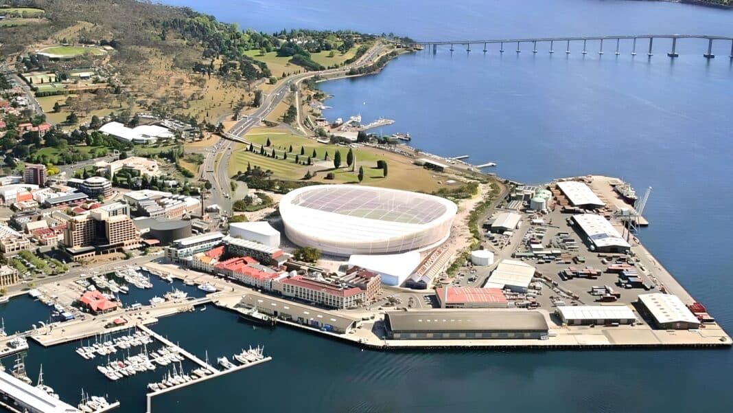 A new $715m Tasmanian AFL Stadium, that was locked in following confirmation that Tasmania will join the AFL and federal funding was committed is now in doubt after the Tasmanian Premier pulled funding earlier this month. The new stadium will be located at Macquarie Point near the heart of Hobart. The latest proposal, approved in October 2024, is a fully-roofed 23,000-seat stadium. (Photo Credit: Mac Point)