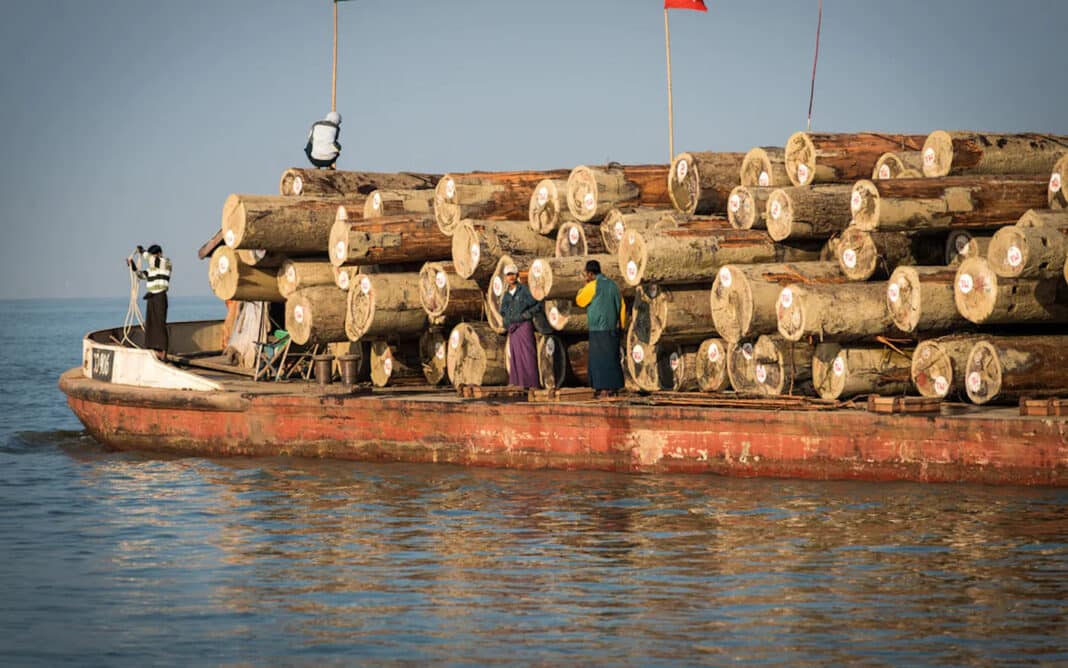 A barge laden with timber floats along the Irrawaddy River in Myanmar
