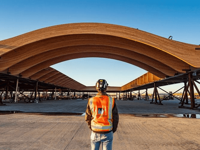 Construction of the massive, curved glulam roof over the main terminal started in 2022. Wood Central can now report that the roof has been installed over the airport, with work now turning to the interior fitout. Phase 1 of the project will open in May 2024, with the project finalised in 2025. (Photo courtesy of Mike Brewington, taken in March 2022)