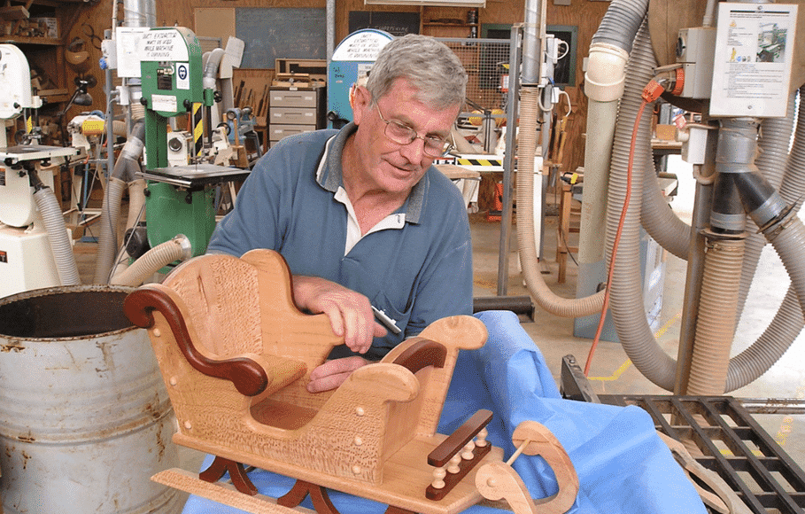 ‘Woodies’ life member Hugh McKenna puts the finishing touches to a child’s sleigh at the guild’s workshop.