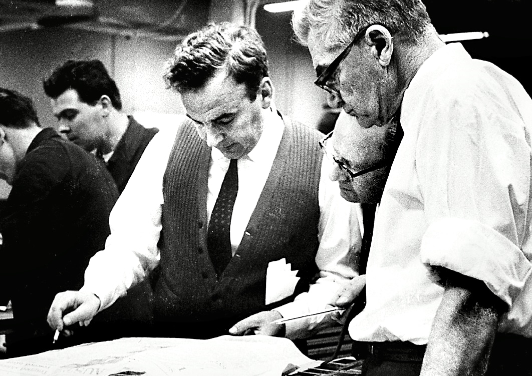 Ruper Murdoch checks the first proof of The Australian in the composing room in Canberra. (Photo Credit: The Australian)