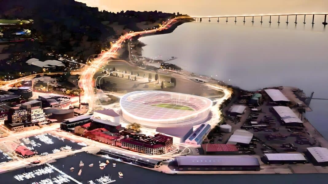 A new $715m Tasmanian AFL Stadium, that was locked in following confirmation that Tasmania will join the AFL and federal funding was committed is now in doubt after the Tasmanian Premier pulled funding earlier this month. The new stadium will be located at Macquarie Point near the heart of Hobart. The latest proposal, approved in October 2024, is a fully-roofed 23,000-seat stadium. (Photo Credit: Mac Point)