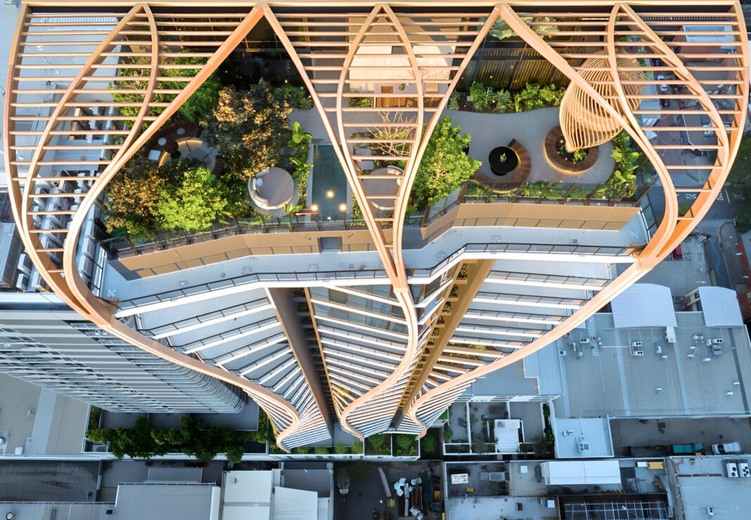 Brisbane is home to a growing number of timber-rich buildings, including the 33-storey Upper House, which now towers West End in inner city Brisbane. Rising above the podium, the tower facade has three meandering timber pillars, which