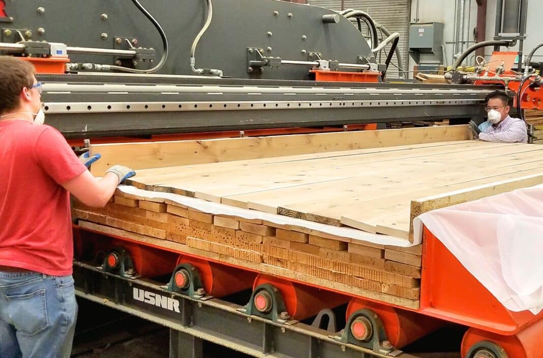 Matthew Clark and Hui Li produce CLT panels with thermally-modified wood at the Research and Technology Park at WSU. (Photo Credit: Supplied by Washington State University)