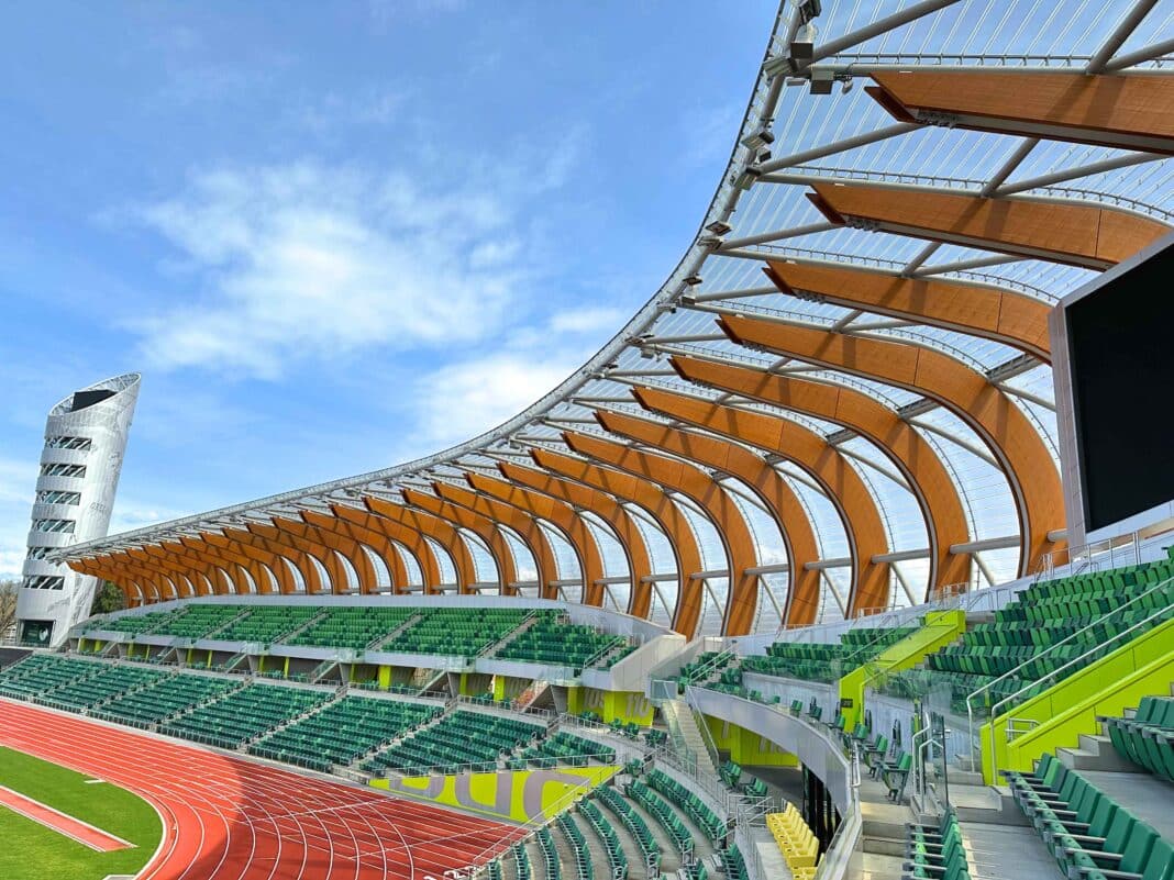 The canopy stretches from the base of the exterior to cover the stands. A metaphor for the body of the athlete guided the canopy's design, with the wood being the ribs