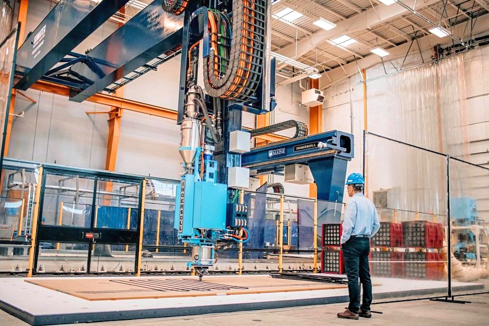 The US government has already invested $93m in a project allowing the Advanced Structures and Composites Center to use wood dust as fuel for the world's largest 3D Printer. (Photo Credit: University of Maine)