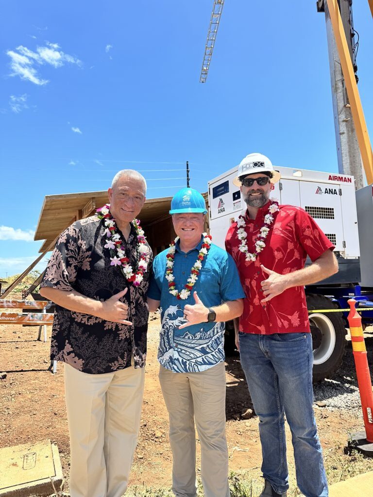 Three project leaders wearing lei and hard hats at the Lahaina mass timber bunkhouse blessing

